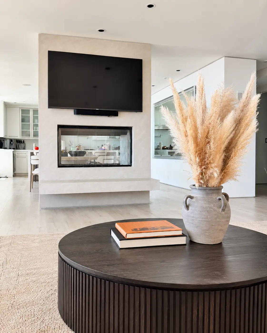 Seamless plaster fireplace and media surround in a warm neutral tone, in a Laguna Beach project.