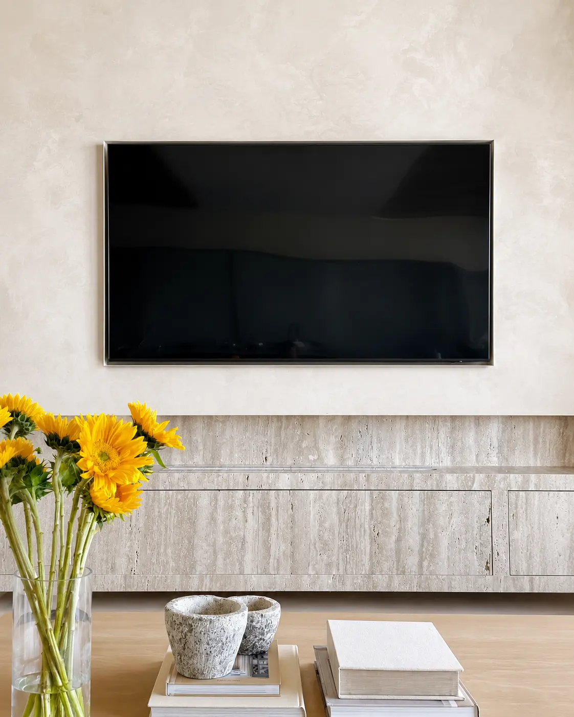 Lime wash living room feature wall in a warm neutral tone behind a wall-mounted television, in a Newport Beach project.