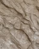 Stone-effect plaster texture sample in taupe with a rugged, natural stone-like surface.