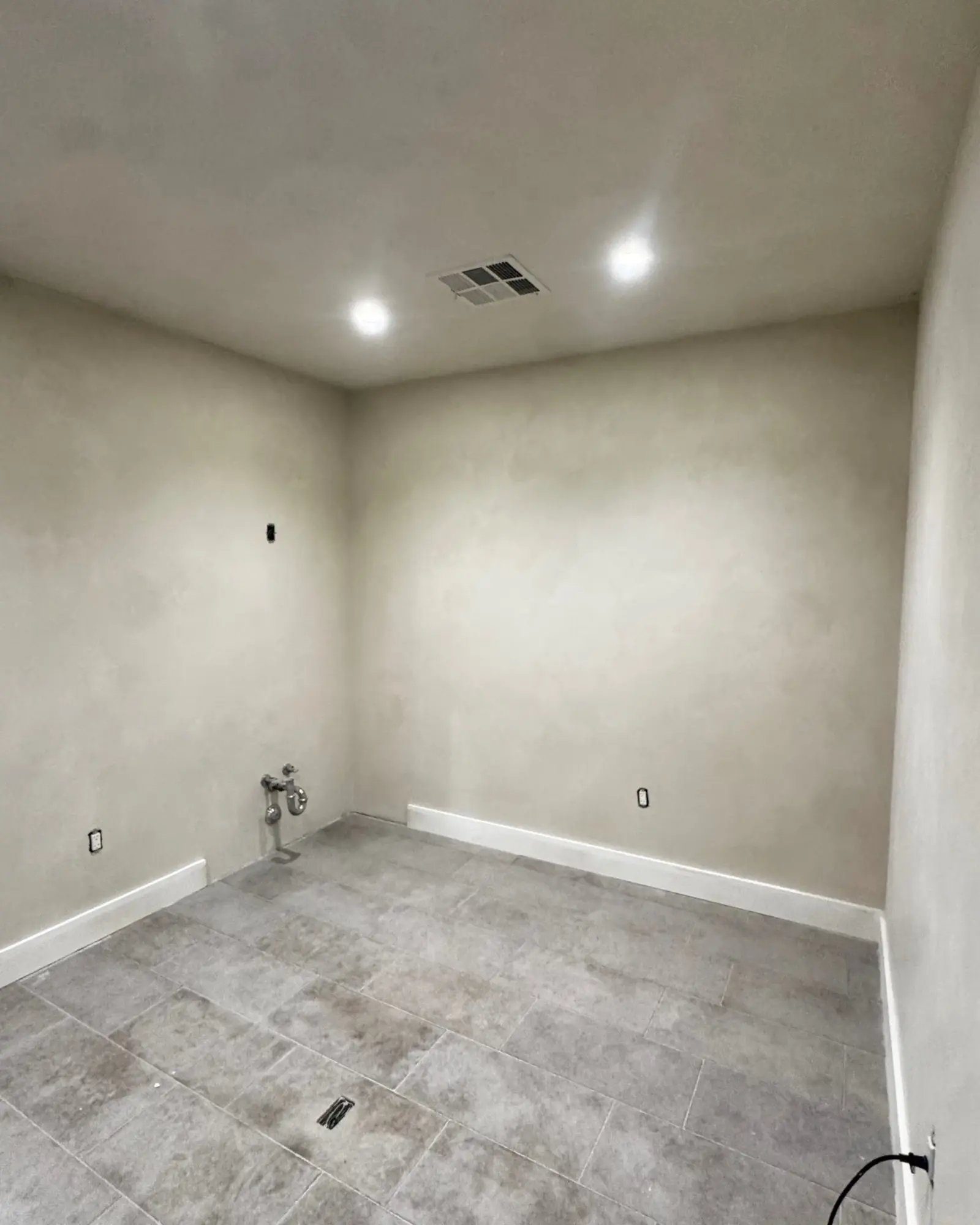 A finished treatment room with lime wash walls in a Costa Mesa med spa.
