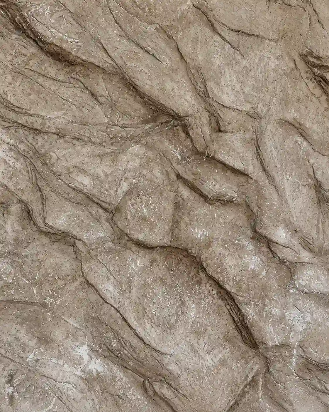 Stone-effect plaster texture sample in taupe with a rugged, natural stone-like surface.