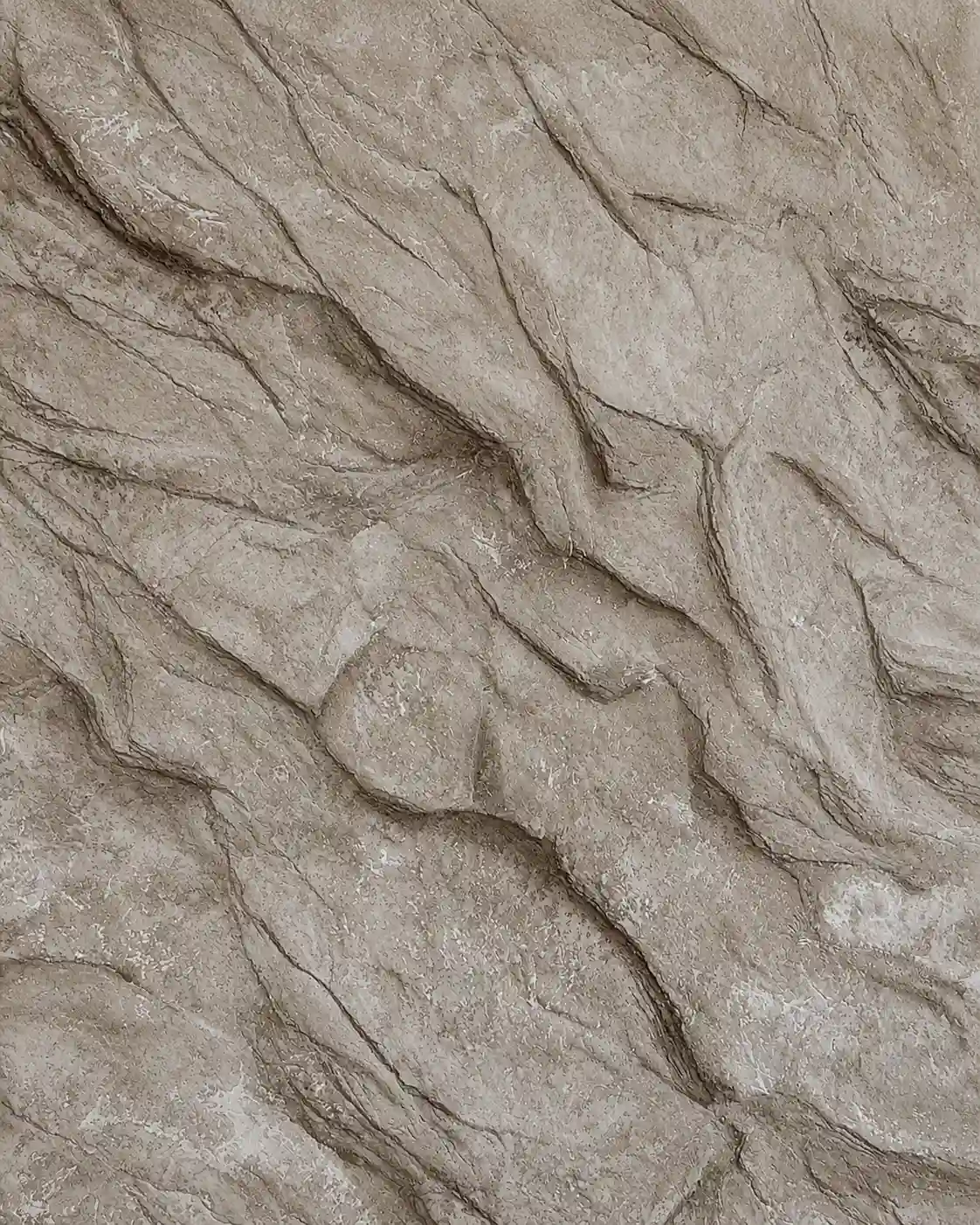Real hand-applied sculpted rock stone-effect plaster sample in warm taupe, with layered natural-rock striations and fissures.