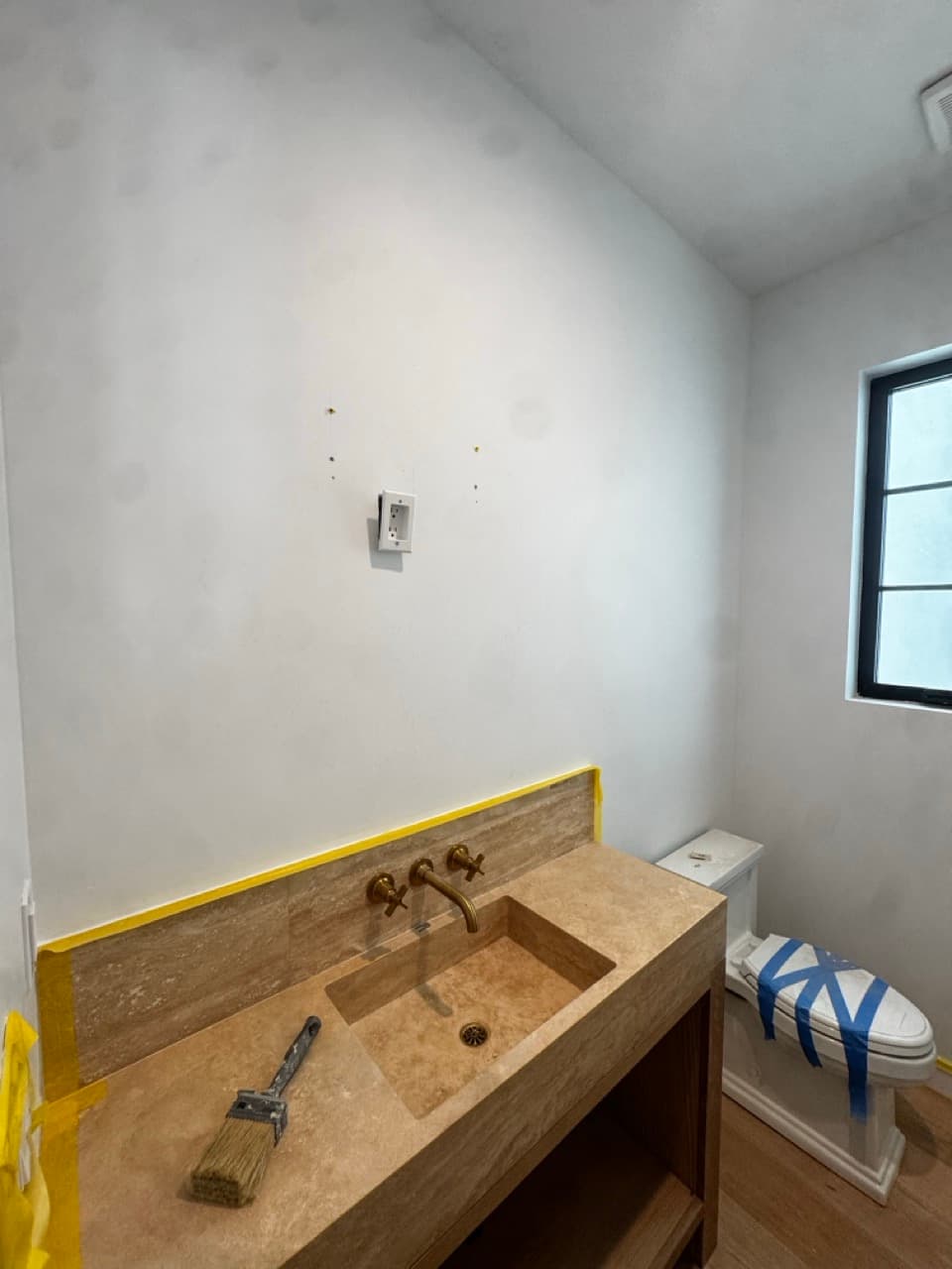 Guest powder room with plain painted walls before Venetian plaster, Newport Beach, Orange County.
