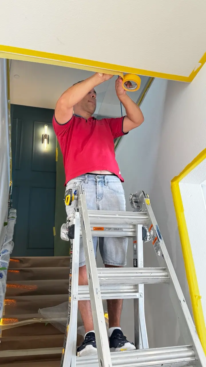 Adjacent stairwell surfaces and edges masked and protected before Venetian plaster application.