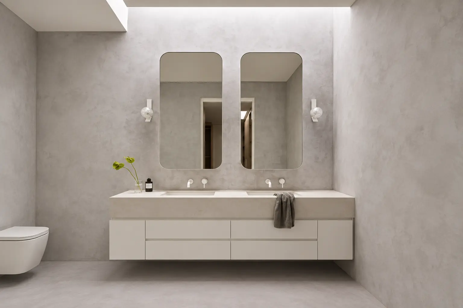 Seamless grout-free microcement shower wall applied over existing tile