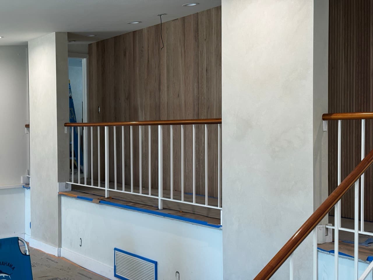 Living room column finished in lime wash beside a wood feature wa