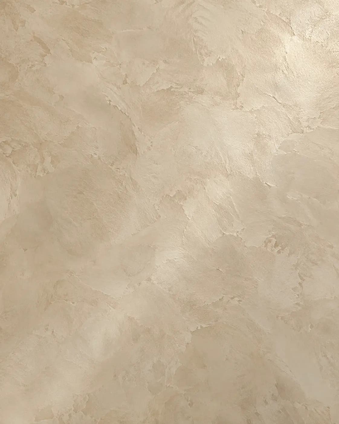 Close-up of warm bone Venetian plaster showing soft cloud-and-trowel movement, fine mineral grain, and gentle burnished sheen