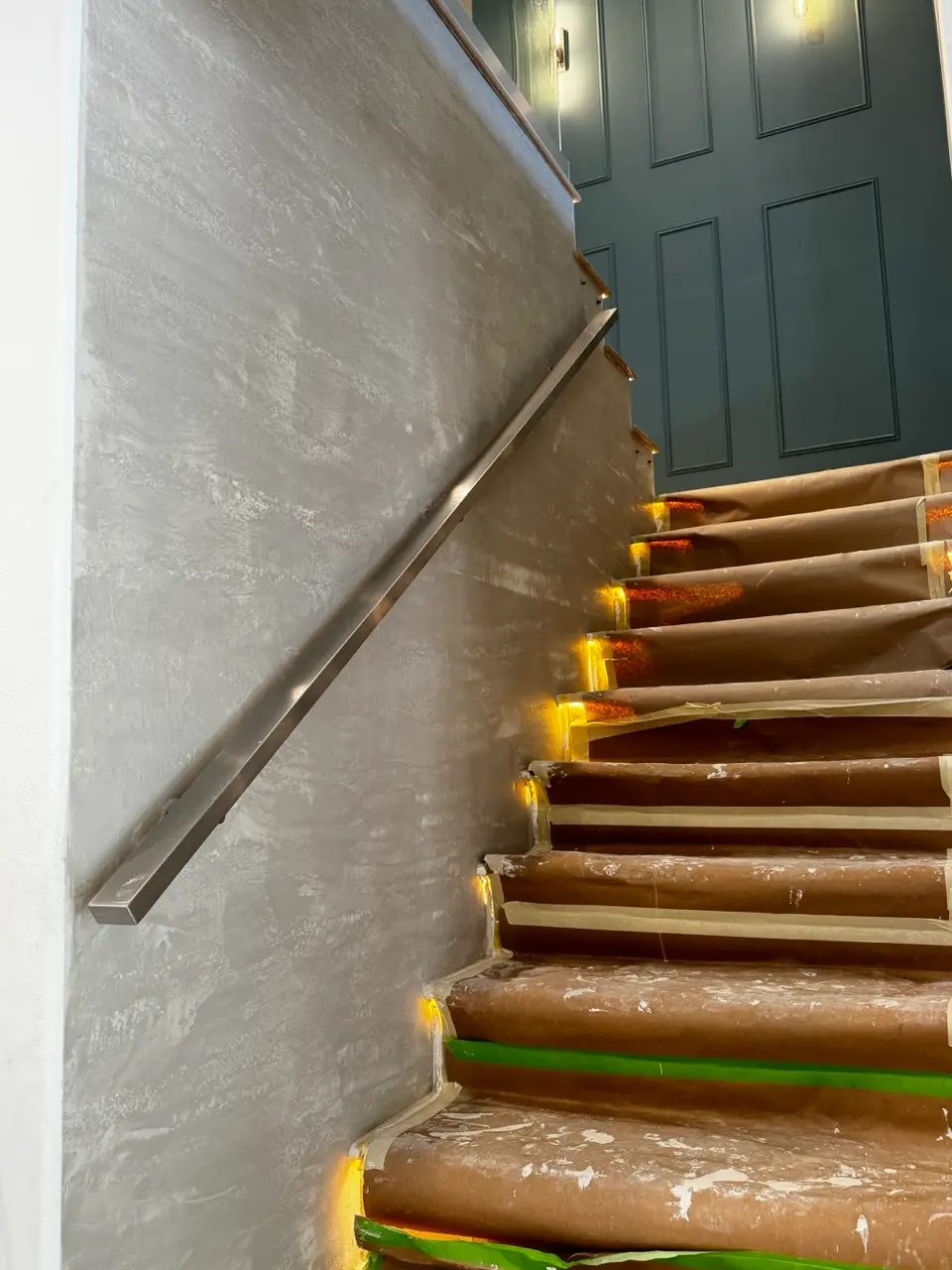 Stairwell wall after the second coat of Venetian plaster with the travertine effect developed.