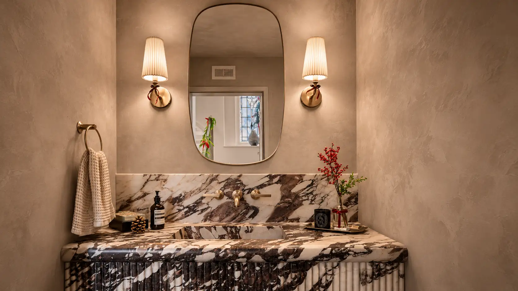 Roman clay powder room walls - matte, velvety clay finish above a marble vanity