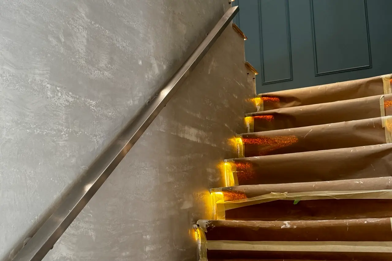 Stairwell wall after the second coat of Venetian plaster with the travertine effect developed.